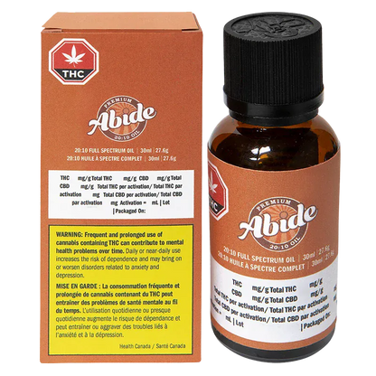 Front view of the 20:10 Full Spectrum Oil Abide 30 ml amber glass bottle with black cap shown next to its brown branded box.