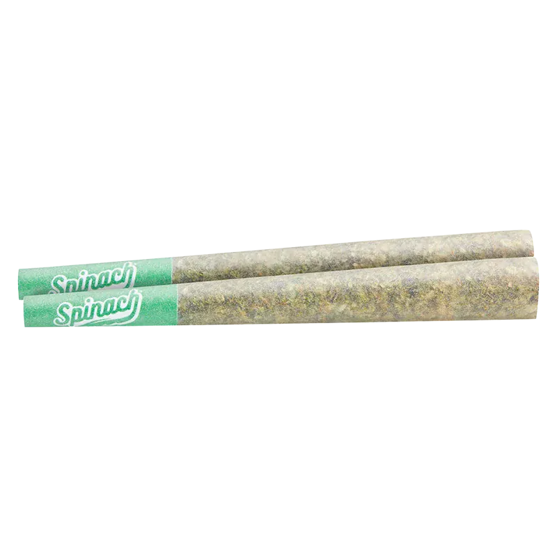 Top-down close view of two rolled joints with green tips labeled "Spinach" representing the GMO Cookies PR 2 x 1 g.