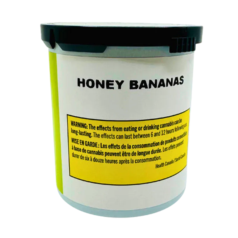 Front-facing view of a white container labeled Honey Bananas with a black lid and a yellow warning panel near the base