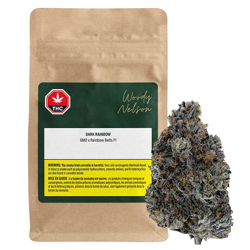 Front view of a brown pouch labeled Woody Nelson Dark Rainbow beside a single frosty purple-green bud on a white background.