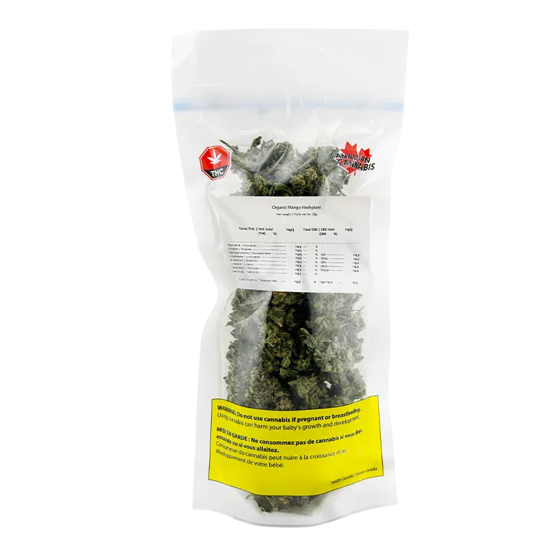 Clear front-facing photo of a sealed pouch labeled Organic Mango Hashplant showing dense green buds and warning labels.
