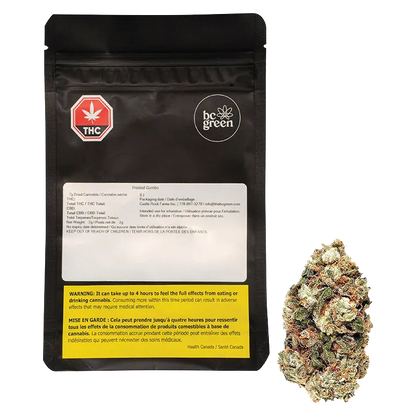 Front view of the black BC Green Frosted Gumbo pouch and a single cannabis bud shown to its right on a white background.