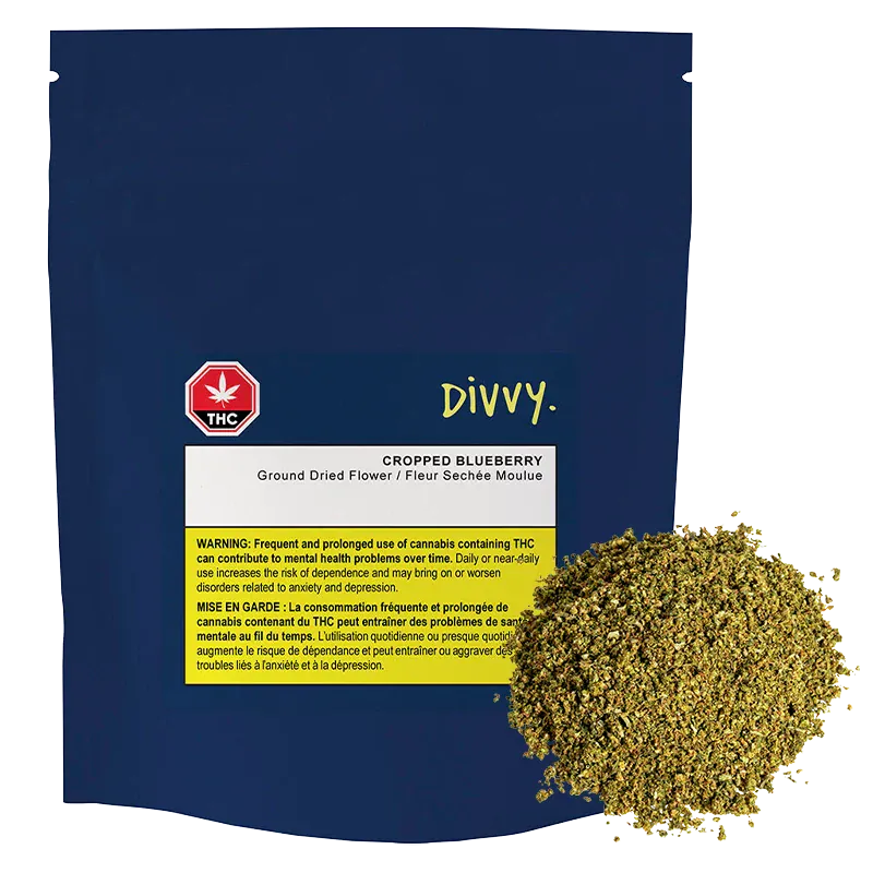 Front-facing pouch of Divvy. Cropped Blueberry with a navy background, white label and a pile of shredded greenish dried flower at the lower right.