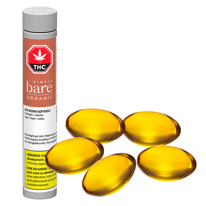 Three-quarter view of a tall white tube labeled "Simply Bare Organic Live Rosin Softgels" standing beside five glossy amber softgel capsules.