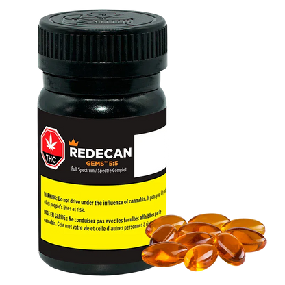 Front view of a black bottle labeled Redecan Gems 5:5 Capsules with a yellow warning panel and amber softgel capsules arranged at its base.