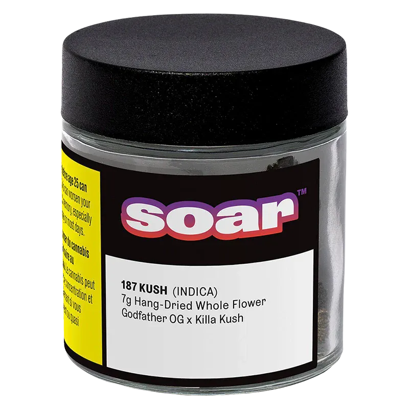 Front three-quarter view of a clear jar labeled "soar 187 Kush" with a black lid, black-and-yellow label and white product text.