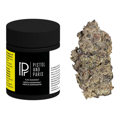 Front view of a black Pistol and Paris Gas Basket jar with its logo and label visible, shown beside a single frosty cannabis bud.