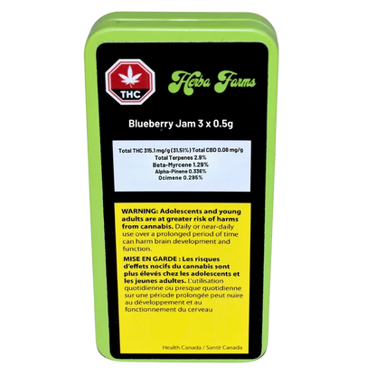 Straight-on view of the lime-green tin labeled "Herba Farms Blueberry Jam 3 x 0.5 g" showing black top panel, THC symbol, terpene table, and a yellow bilingual warning block.