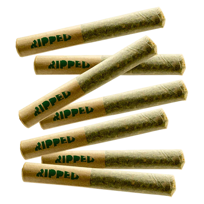 Angled top-down view of seven rolled joints labeled "Sour x Papaya PR 7 x 0.5 g" with brown paper tips printed "RIPPED" against a white background