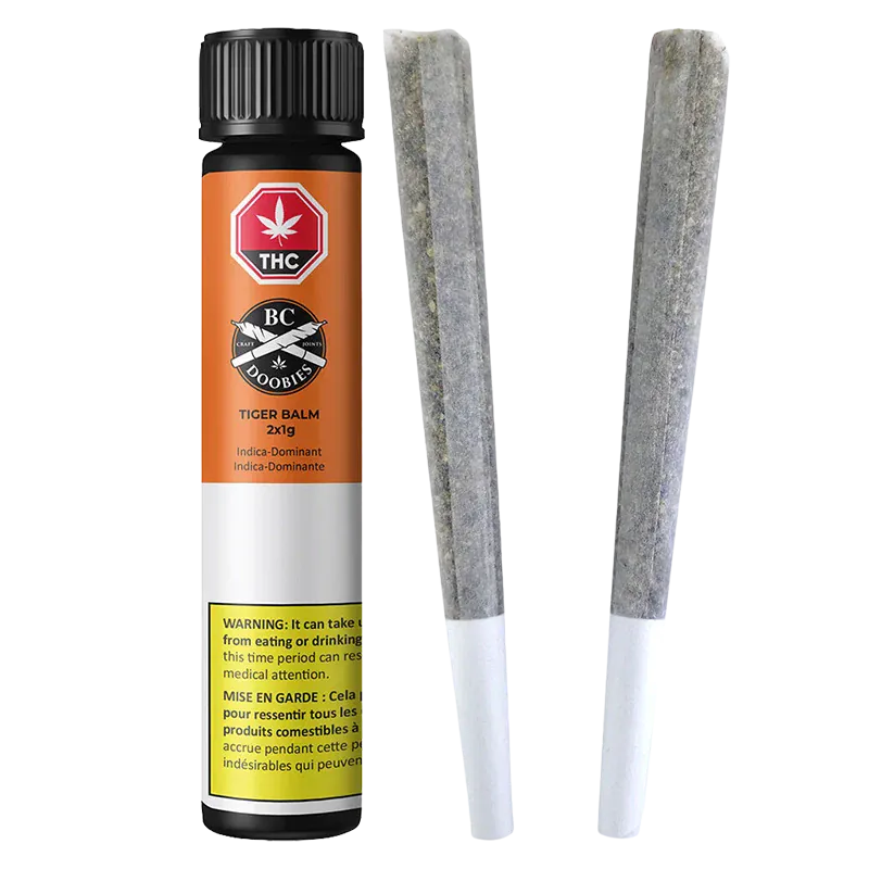 Vertical product shot of Tiger Balm PR 2 x 1 g showing the orange-and-white cylindrical tube with warning label beside two pre-rolled joints.