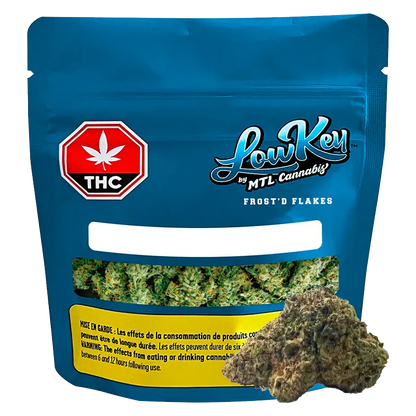 Front-facing pouch of Frost'd Flakes by LowKey showing a blue resealable bag with a THC symbol, window of green buds, and a bud in front.