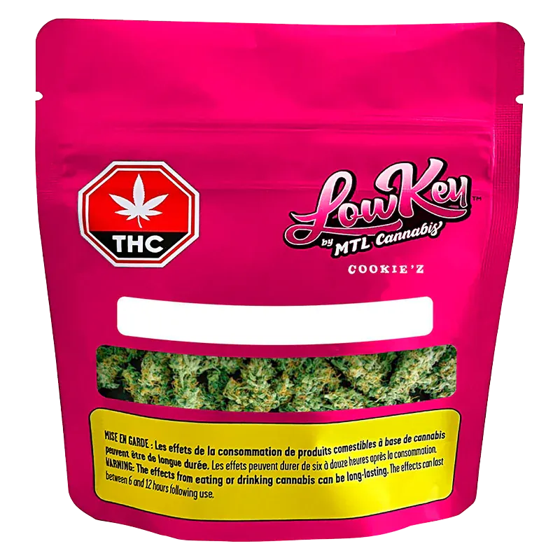 Front-facing pouch of Cookie'z by LowKey showing a bright magenta package with a THC symbol and a clear window revealing green cannabis buds.