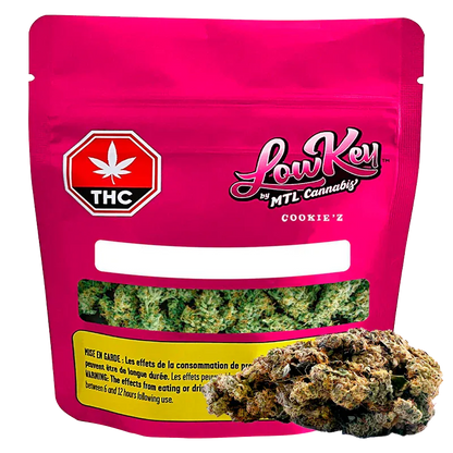 Front-facing pouch shot of the bright pink Cookie'z package by LowKey with a clear window showing green buds and a THC symbol.