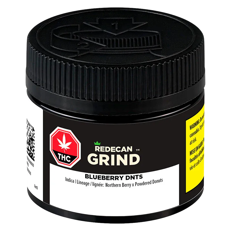 Close-up front view of a black jar labeled "Blueberry DNTs Grind" by Redecan Grind, showing textured screw-top lid and warning labels.