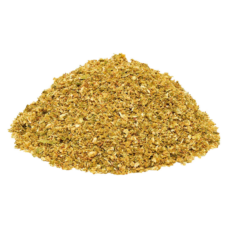 Close-up of a mound of golden-green Blueberry DNTs Grind on a white background, showing coarse, flaky texture and mixed leaf pieces.