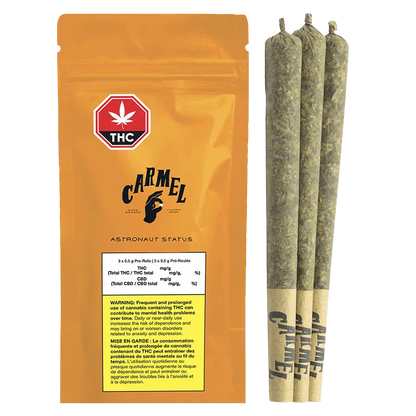 Front-facing shot of the orange Carmel Astronaut Status PR 3 x 0.5 g pouch beside three rolled joints standing upright on a white background