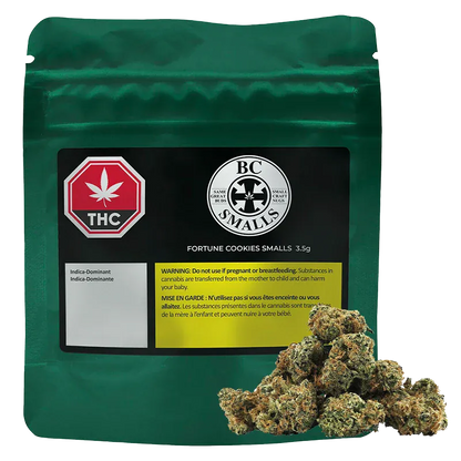Front-facing green pouch labeled "Fortune Cookies Smalls" with a black product label, THC symbol, and cannabis buds piled at the lower right.