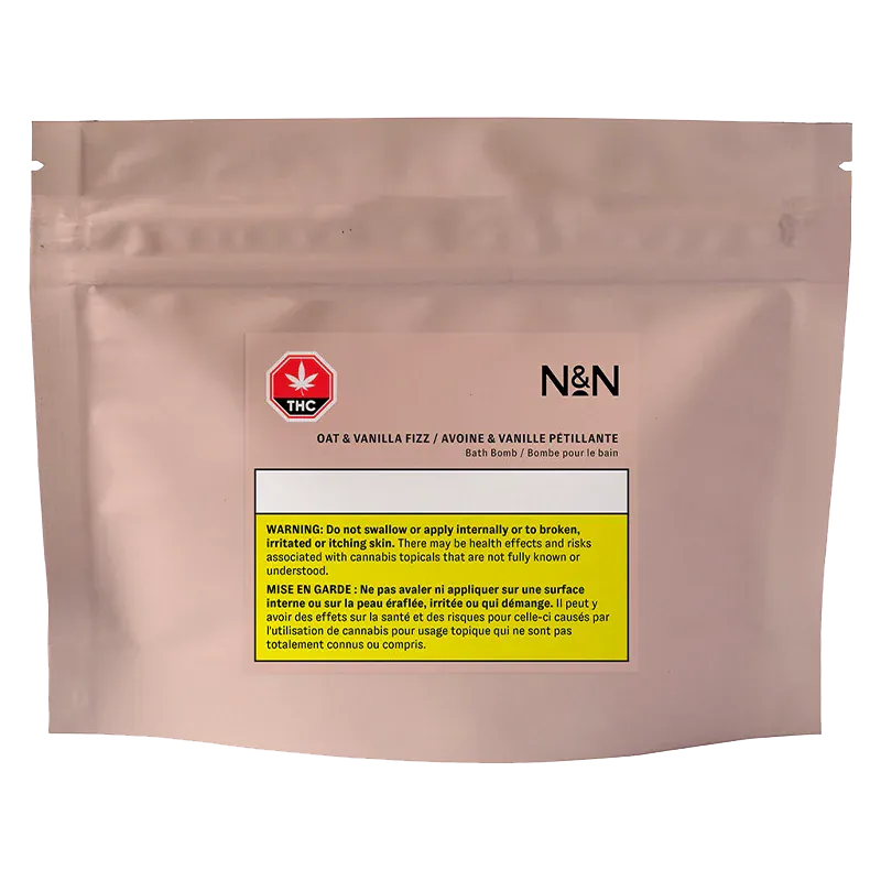 Front-facing shot of the blush pouch labeled N&N Oat & Vanilla Fizz Bath Bomb with a THC symbol and yellow warning block centered on the front.