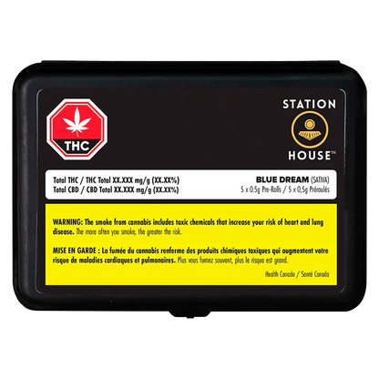 Top-down view of a black rectangular tin labeled Station House with the Blue Dream PR 5 x 0.5 g product name and a yellow health warning panel.