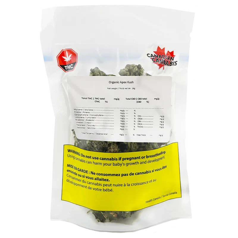 Clear front-facing shot of a sealed bag labeled Organic Apex Kush showing cannabis buds through the pouch and a prominent yellow health warning.