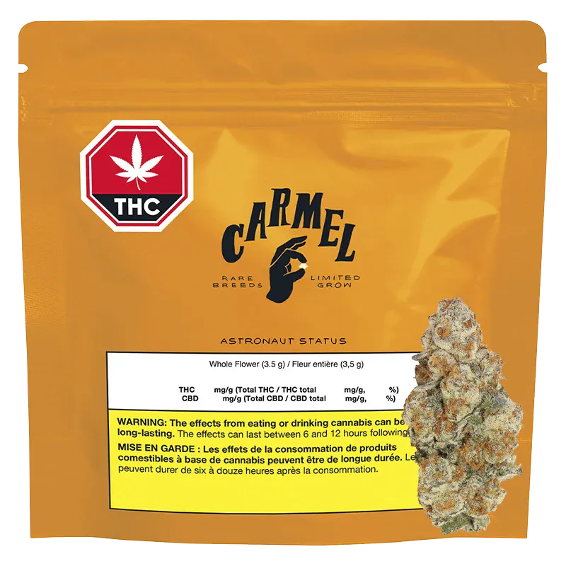 Front-facing shot of the golden pouch labeled "Carmel Astronaut Status" with a THC symbol at top left and a cannabis bud image overlapping the lower right.