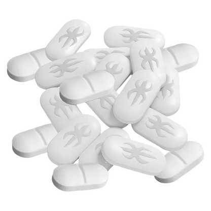 Close-up top-down view of a scattered pile of white Live Rosin Tabs showing pill-shaped tablets with a stylized flame emboss.