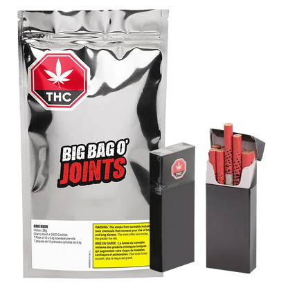 Front view of a reflective silver pouch and two black boxes with red-filtered joints, labeled GMO Kush PR 70 x 0.4 g.
