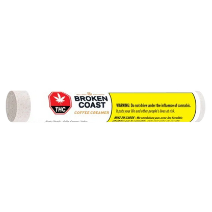 Side view of a white tube labeled Broken Coast Coffee Creamer Blunt PR 1 x 1 g with a red THC symbol and yellow warning panel.