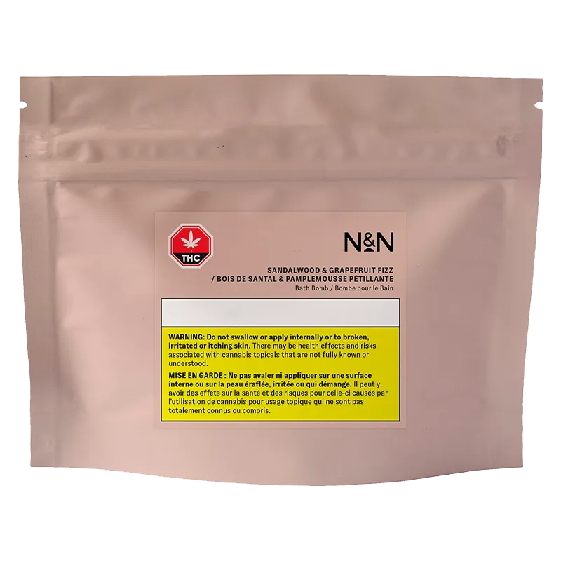 Front-facing shot of the N&N Sandalwood & Grapefruit Fizz Bath Bomb resealable blush pouch with a centered label and yellow THC warning block.