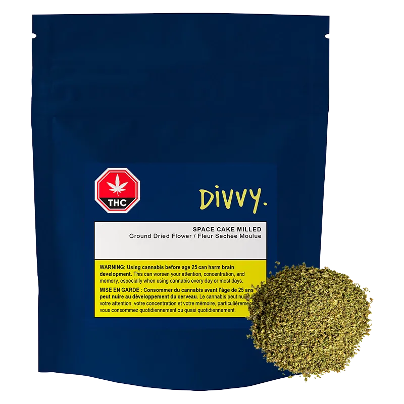 Front view of the navy pouch labeled "DIVVY. SPACE CAKE MILLED" with a white and yellow warning panel and a mound of milled herb at the lower right.