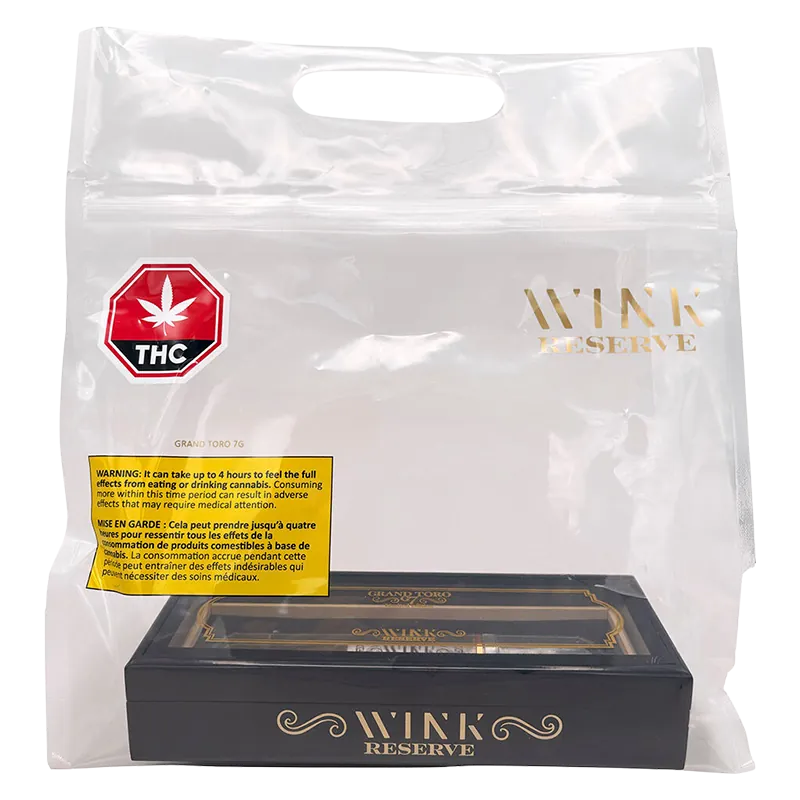 Clear studio-shot of a black and gold box labeled Reserve Grand Toro G7 PR 1 x 7 g inside a transparent Wink Reserve branded carry bag.