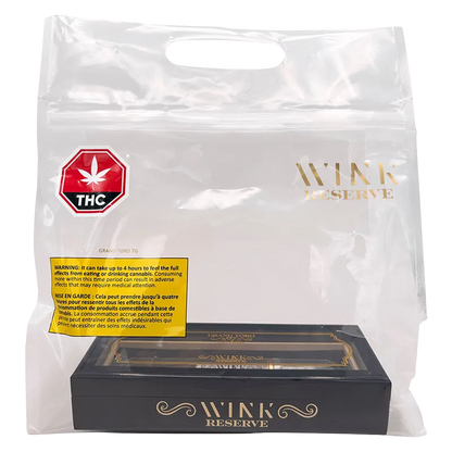 Clear studio-shot of a black and gold box labeled Reserve Grand Toro G7 PR 1 x 7 g inside a transparent Wink Reserve branded carry bag.