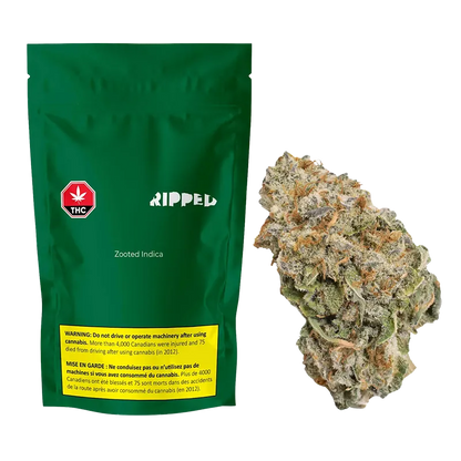 Green Ripped pouch labeled Zooted Indica stands upright next to a close-up of a frosty, orange-tinted cannabis bud.