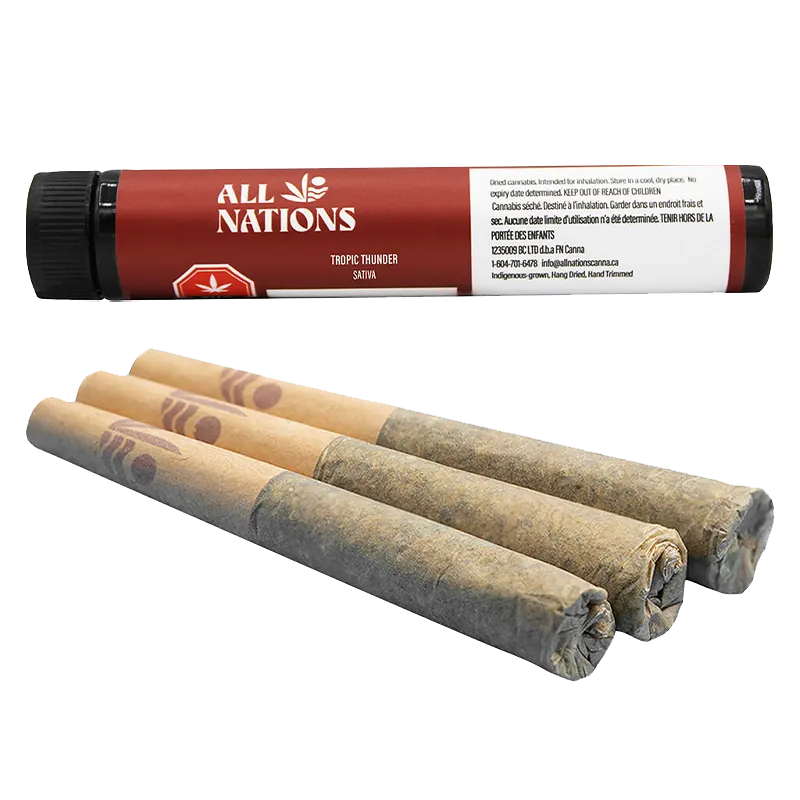 Angled close-up of three hand‑rolled joints in front of a red tube labeled Tropic Thunder PR 3 x 0.5 g by All Nations.