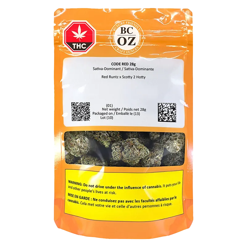 Front-facing shot of the orange BC OZ Code Red pouch showing a clear window of green cannabis buds and warning labels.