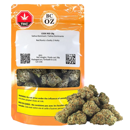 Front-facing shot of the Code Red 28 g pouch with orange packaging, visible product window and a pile of green buds at its base.