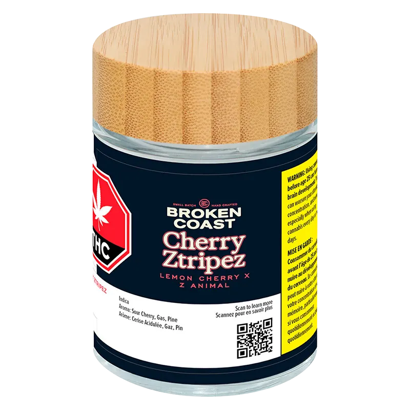 Front-facing shot of the Broken Coast Cherry Ztripez jar with its bamboo lid, navy label and visible warning panel.