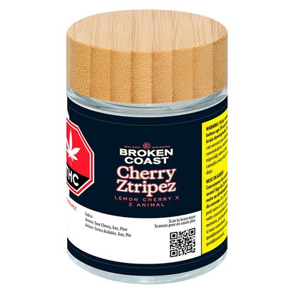 Front-facing shot of the Broken Coast Cherry Ztripez jar with its bamboo lid, navy label and visible warning panel.