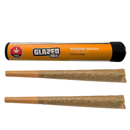 Top-down view of a Glazed PR 2 x 1 g black and orange tube labeled "GLAZED BOLD" with two pre-rolls laid below.