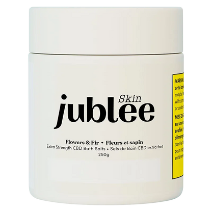 Front-facing shot of the white jar labeled "jublee Skin Flowers & Fir Extra Strength CBD Bath Salts" on a plain white background.