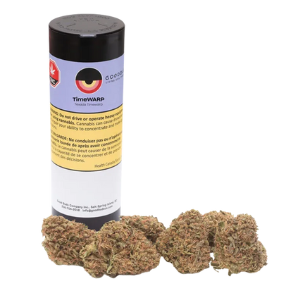 Cylindrical black-lidded TimeWARP container labeled Timewarp stands behind five loose, green-brown cannabis buds on a white background.