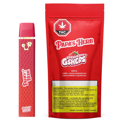 Three-quarter view of a red Strawberry Gshers Saucy Diamond Disposable Vape standing next to its matching red Papa's Herb pouch, both shown on a white background.
