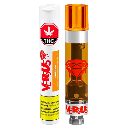 Straight-on product shot of the Tropic OG Liquid Diamonds Vape Cartridge by Versus showing the transparent 1 g cartridge with amber oil and red dripping-diamond logo beside its white branded tube.