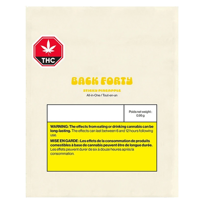 Cream-colored package front photographed straight-on showing the Back Forty Sticky Pineapple All-In-One Disposable Vape branding, THC symbol and yellow warning box.