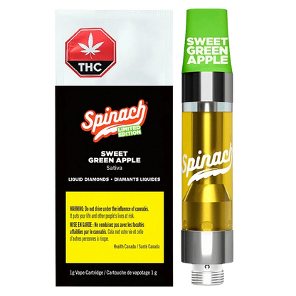 Right-side view of the Sweet Green Apple Liquid Diamonds Vape Cartridge by Spinach, showing the green cap, golden liquid chamber, and black-and-white branded box beside it.
