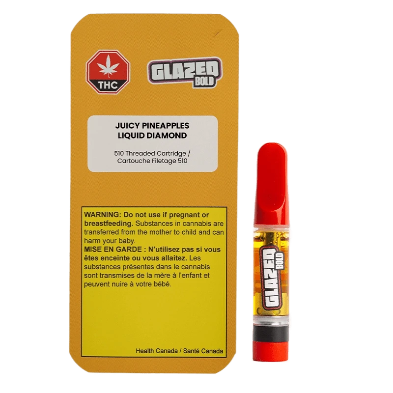 Bright studio front view of the Juicy Pineapples Liquid Diamond Vape Cartridge showing its yellow-labeled box with warning panel beside a red-tipped 1 g cartridge.