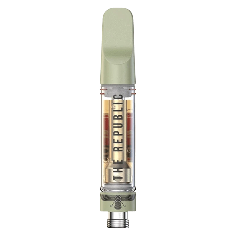 Top-down close-up of a green-tipped Black Label Vape Cartridge showing the clear chamber and "THE REPUBLIC" branding inside.