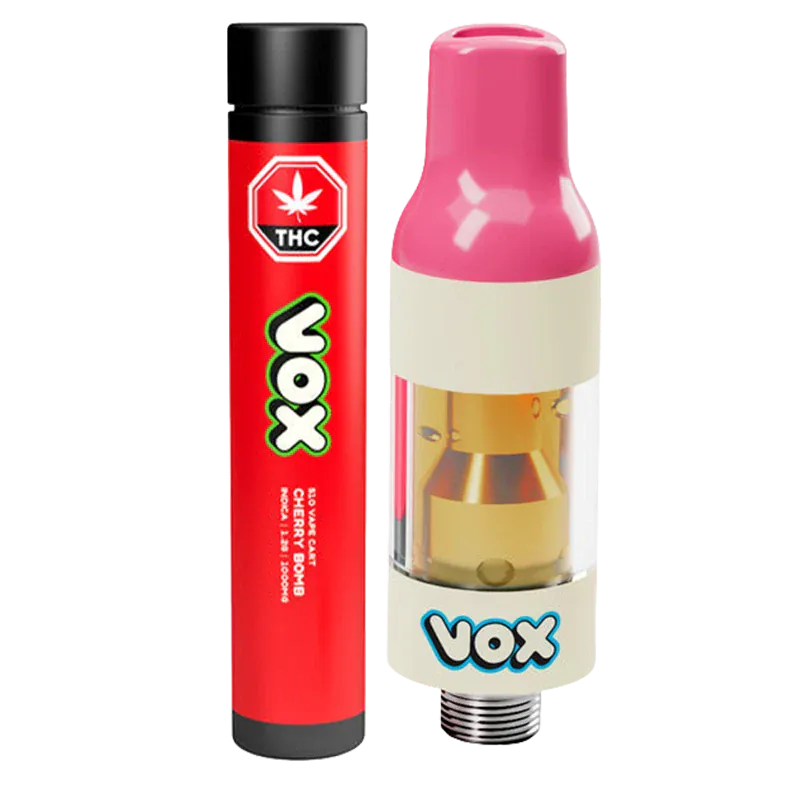 Close-up of a pink-topped VOX Cherry Bomb Vape Cartridge beside its red VOX-branded tube, shown on a white background.