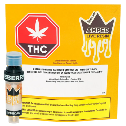 A front-facing shot of the Amped Live Resin Blueberry DNTS Vape Cartridge standing beside its yellow branded packaging, both shown on a white background.