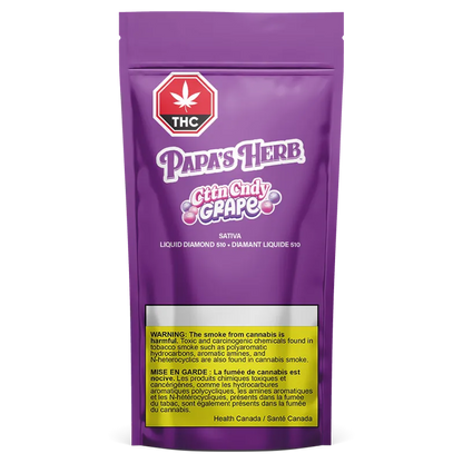 Front-facing shot of a purple pouch labeled CttnCndy Grape Liquid Diamond Disposable Vape with bold "Papa's Herb" logo and a yellow health warning.